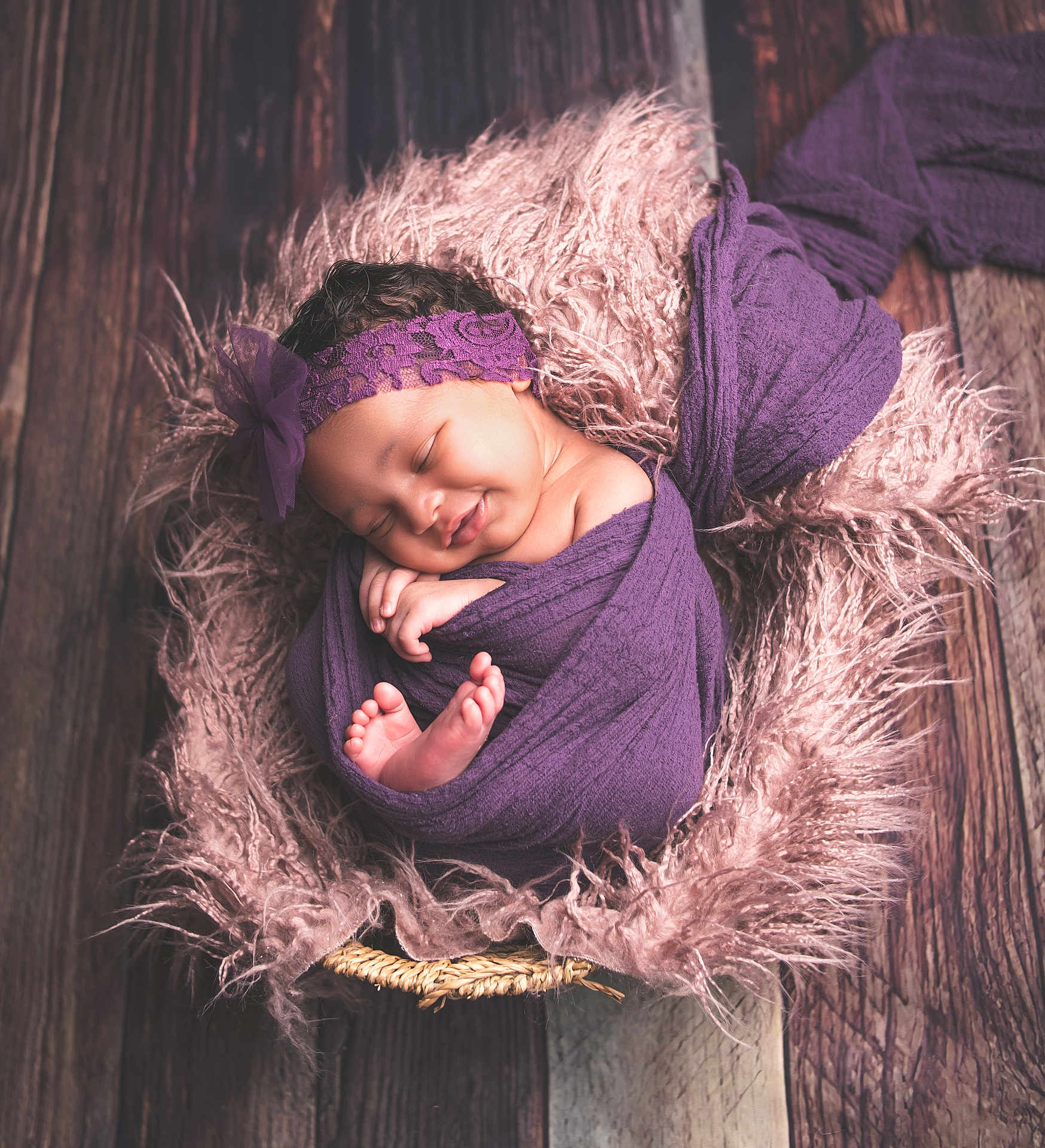 Jahsani joined the competition — help win amazing prizes! baby, newborn, sleeping, purple_cloth, headband, fluffy_blanket, pink, wooden_floor, wrapped, closeup, peaceful, cute, infant, portrait, cozy, soft_texture, smiling, hands, feet, indoor