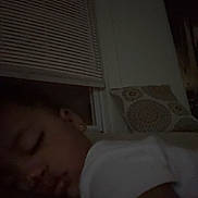 Starr is registered to the contest to win money with this photo: child, sleeping, indoor, pillow, window, blinds, dark, cozy, bedtime, face, peaceful, resting, person, closeup, calm, young, eyelids_closed, toddler, white_shirt, earring