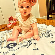 Zora joined the competition — help win amazing prizes! baby, child, headband, bow, blanket, animal_print, indoor, carpet, cute, sitting, infant, clothing, hand, foot, face, wide_eyes, person, toy, room, floor