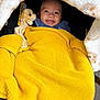 Isa Elah Raah joined the competition — help win amazing prizes! baby, blanket, yellow, smile, toy, plush, face, infant, cozy, knit, child, car_seat, happy, cute, warm, fabric, person, head, expression, comfort