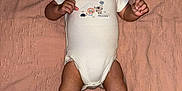 Isa Elah Raah is registered to the contest to win money with this photo: baby, infant, onesie, lying_down, blanket, pink, cute, face, hands, legs, feet, clothing, child, portrait, skin, expression, indoors, newborn, person, young