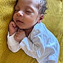 baby, sleeping, infant, white_clothing, blanket, yellow, knit, cozy, cute, peaceful, newborn, face, closed_eyes, hands, soft, portrait, resting, child, indoors, comfort
