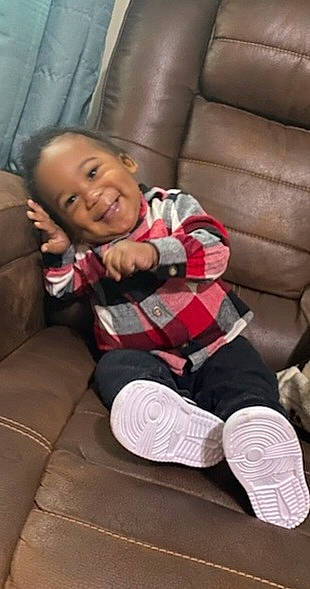 Karsyn is registered to the contest to win money with this photo: comfort, couch, flooring, happy, hardwood, human_leg, joy, knee, lap, leg, linens, pattern, person, plaid, sitting, smile, sock, tartan, textile, thigh