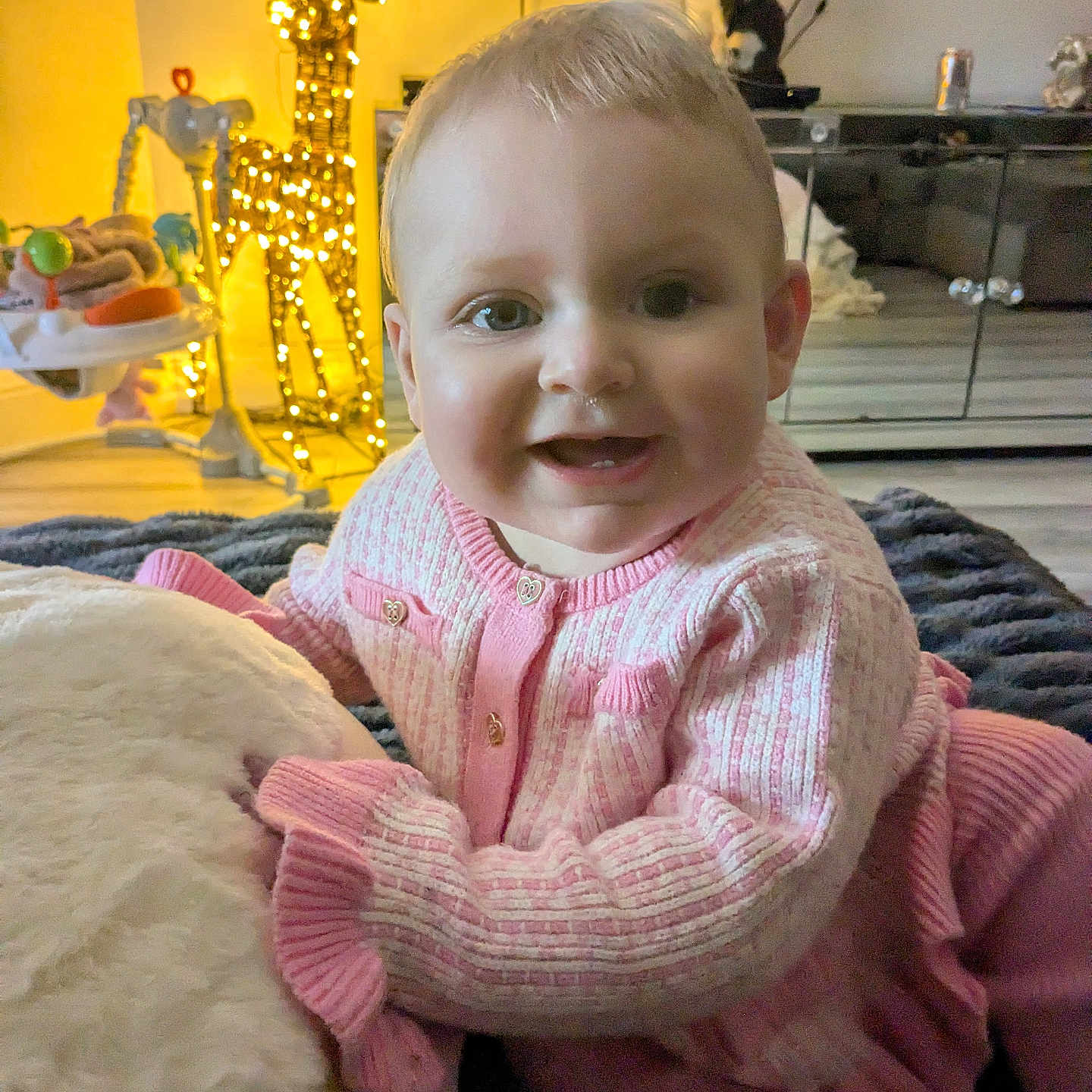 Evie joined the competition — help win amazing prizes! animal, architecture, baby, building, cat, clothing, couch, face, furniture, head, indoors, knitwear, livingroom, person, pet, photography, portrait, room, sitting, sweater