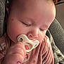 Briar is registered to the contest to win money with this photo: baby, sleeping, pacifier, hand, pink_clothing, infant, closeup, face, peaceful, child, person, soft_lighting, cute, cozy, indoor, skin, eyelashes, napping, comfort, newborn