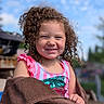 Jaquelyn Marie Kai Wilson joined the competition — help win amazing prizes! blue_sky, child, curly_hair, cute, daylight, fun, girl, happy, nature, outdoor, person, pink_clothing, playful, portrait, sequins, smile, summer, sunny, towel, young