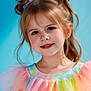 child, girl, portrait, smile, happy, face, hair, pigtails, blue_background, pastel_colors, dress, ruffles, cute, childhood, fashion, innocence, young, pretty, studio, colorful