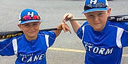 Ethan Zachary is registered to the contest to win money with this photo: baseball, bat, blue_clothing, casual, child, competition, fun, hat, kids, outdoor, parking_lot, pose, recreation, sports, summer, sunglasses, team, two_people, uniform, young_athlete