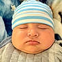 Erick joined the competition — help win amazing prizes! baby, infant, sleeping, closed_eyes, cheeks, hat, striped_hat, blue_blanket, quilted_clothing, onesie, portrait, close_up, face, peaceful, cozy, indoors, soft_texture, nap, newborn, adorable