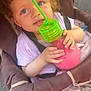 Inaya a rejoint le concours — aidez-le/la à gagner de superbes lots ! toddler, child, stroller, drink, cup, green_straw, pink_liquid, curly_hair, outdoor, casual_clothing, seatbelt, happy, cute, daylight, playful, small_hands, face, portrait, expression, baby