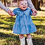 baby, child, denim_dress, white_boots, outdoor, grass, autumn, sunlight, person, hands, smile, walking, support, tree, nature, happy, cute, young_child, portrait, holding_hands
