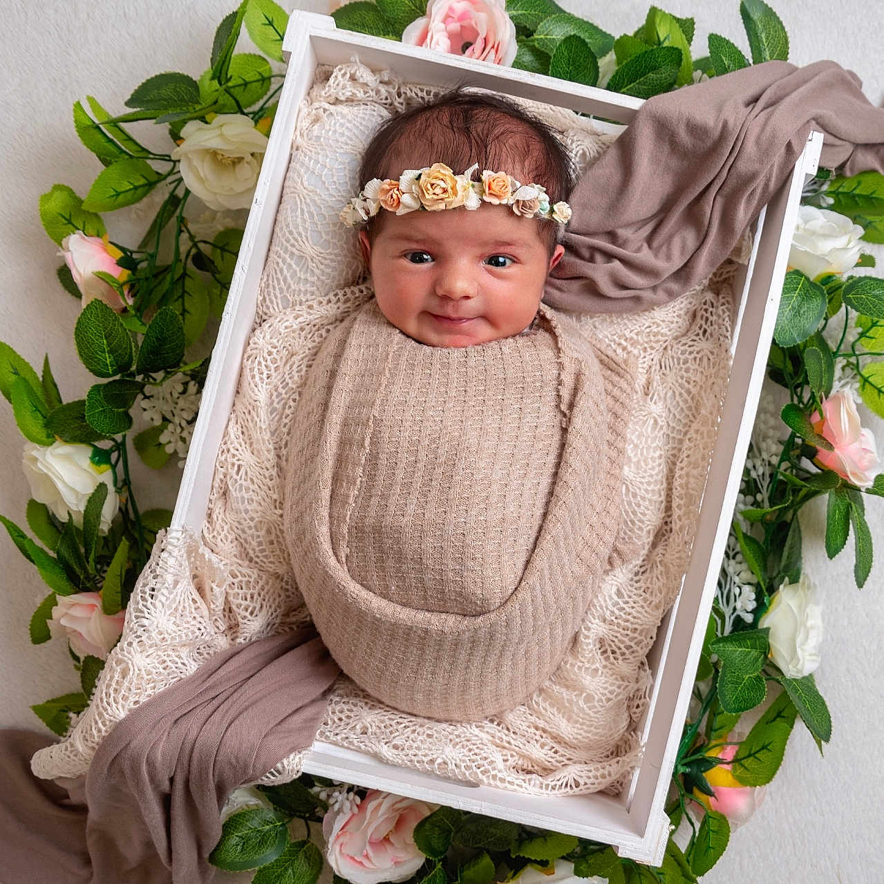 Ayda is registered to the contest to win money with this photo: baby, blanket, crib, face, flower, furniture, head, infantbed, person, plant, rose