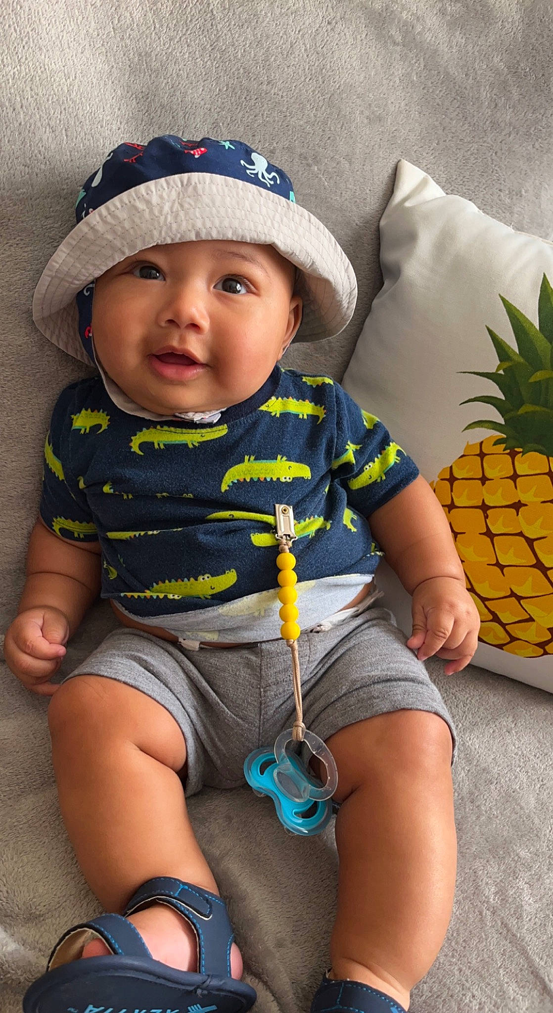 Kylan joined the competition — help win amazing prizes! ananas, arm, baby_toddler_clothing, blue, cap, cool, face, facial_expression, finger, hand, happy, headgear, headwear, organ, person, photograph, pineapple, product, skin, sleeve