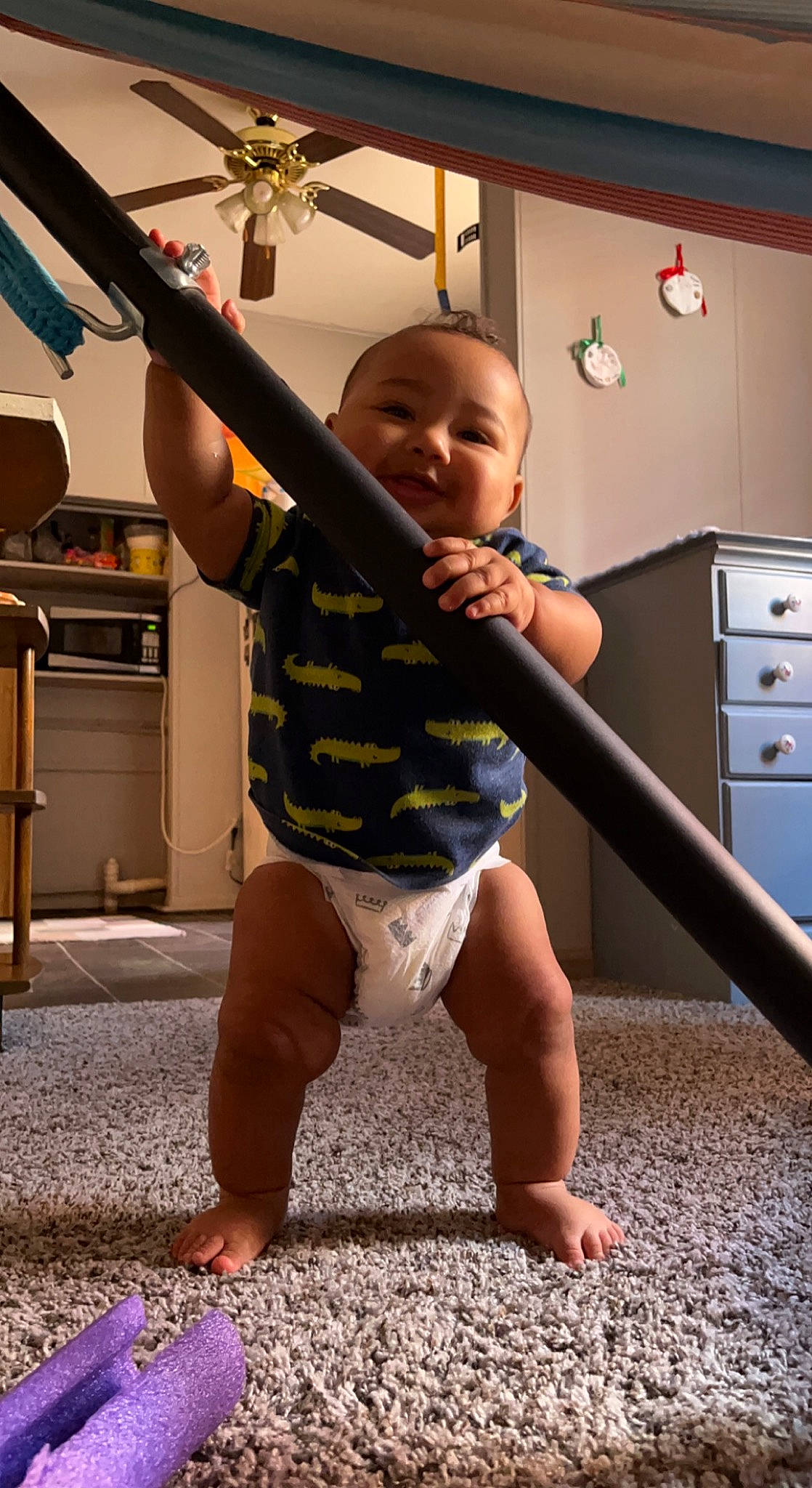 Kylan is registered to the contest to win money with this photo: baby, baby_toddler_clothing, barefoot, cabinetry, chest_of_drawers, drawer, floor, flooring, fun, happy, human_body, joint, leg, person, shoulder, smile, standing, t_shirt, thumb, toddler
