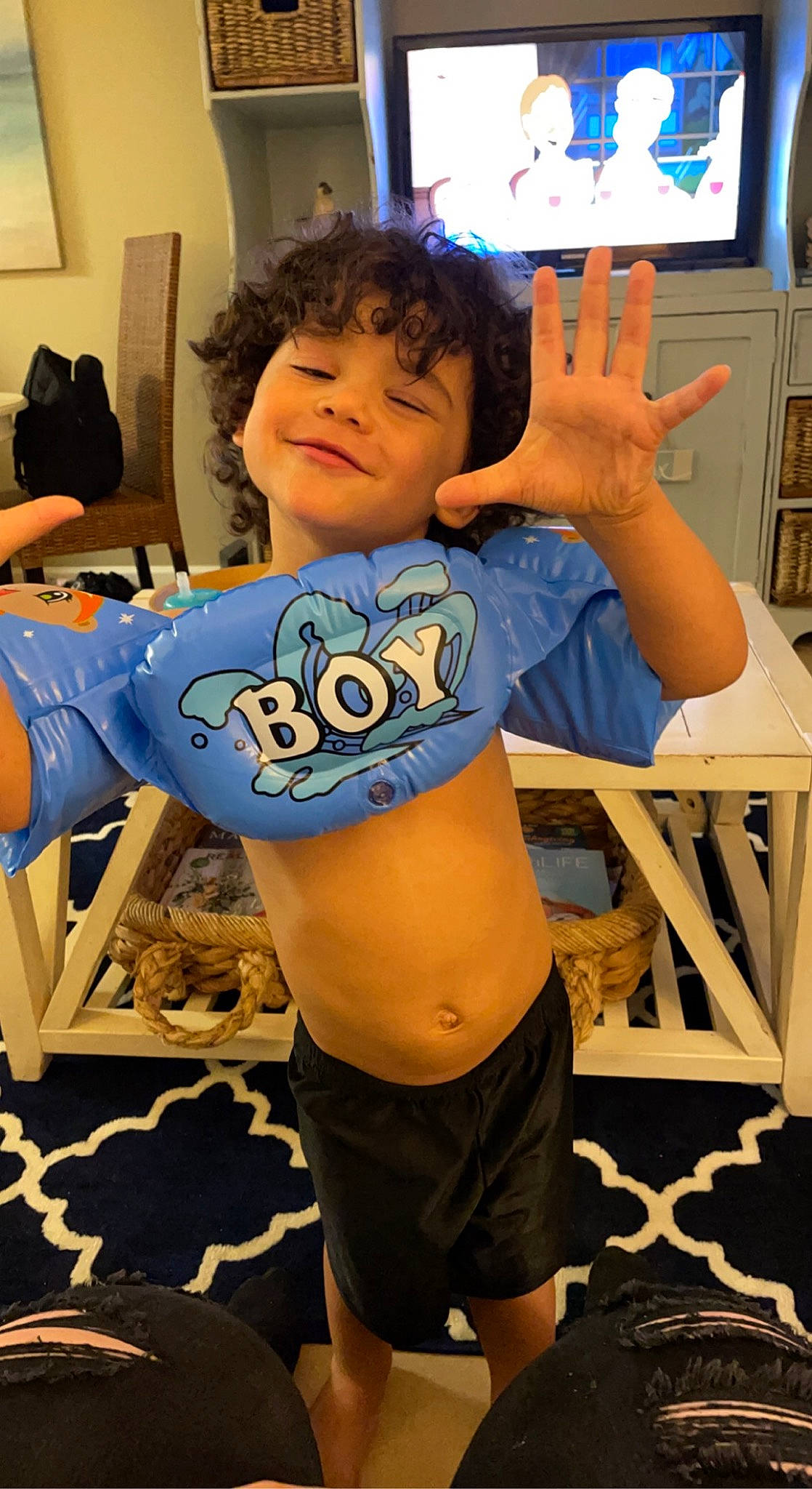 Keenan is registered to the contest to win money with this photo: abdomen, arm, clothing, cool, finger, hairstyle, happy, joint, joy, leisure, muscle, neck, person, shorts, shoulder, sleeve, standing, t_shirt, television, thigh