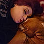 affection, bond, brown_dog, closeup, comfort, companion, cozy, cuddle, dog, face, indoor, love, patterned_background, person, pet, portrait, resting, sleepy, snuggling, warm_lighting