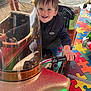 Ilyandro a rejoint le concours — aidez-le/la à gagner de superbes lots ! child, smiling, amusement_ride, handlebar, vest, jeans, spiderman, dog, adult, puzzle_floor, outdoor, happy, play_area, vehicle, glitter, reflection, person, toy, colorful, fun