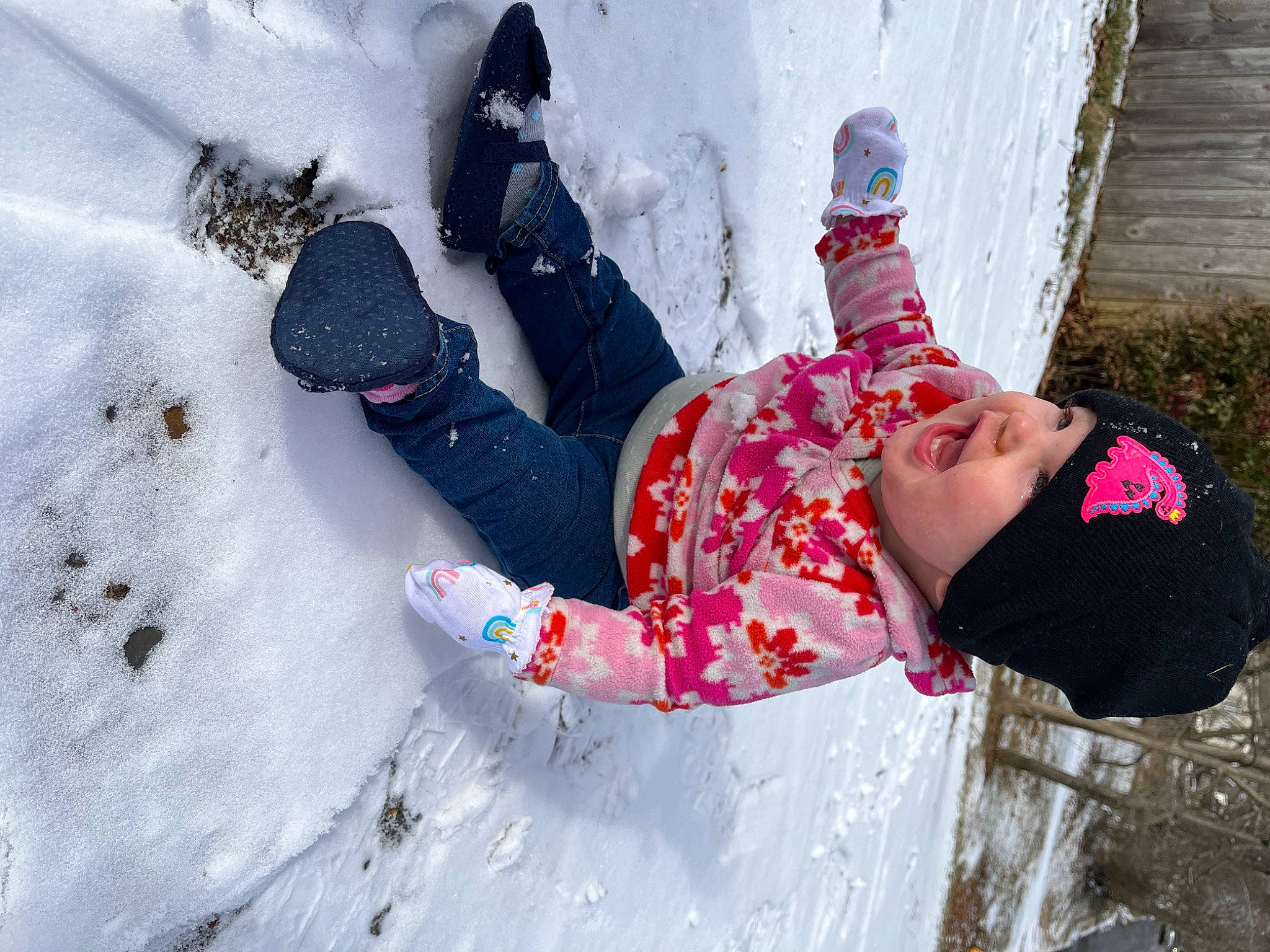 Carolina is registered to the contest to win money with this photo: boot, child, freezing, fun, glove, happy, headwear, jacket, leg, leisure, pattern, people_in_nature, person, playing_in_the_snow, precipitation, recreation, sitting, slope, snow, toddler