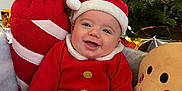 Victory participe au concours pour gagner de l'argent avec cette photo : baby, candy_cane, celebration, child, christmas, cute, decoration, festive, gingerbread_man, green_tree, happy, hat, holiday, indoors, plush_toy, portrait, red_clothing, santa_claus, seasonal, smile