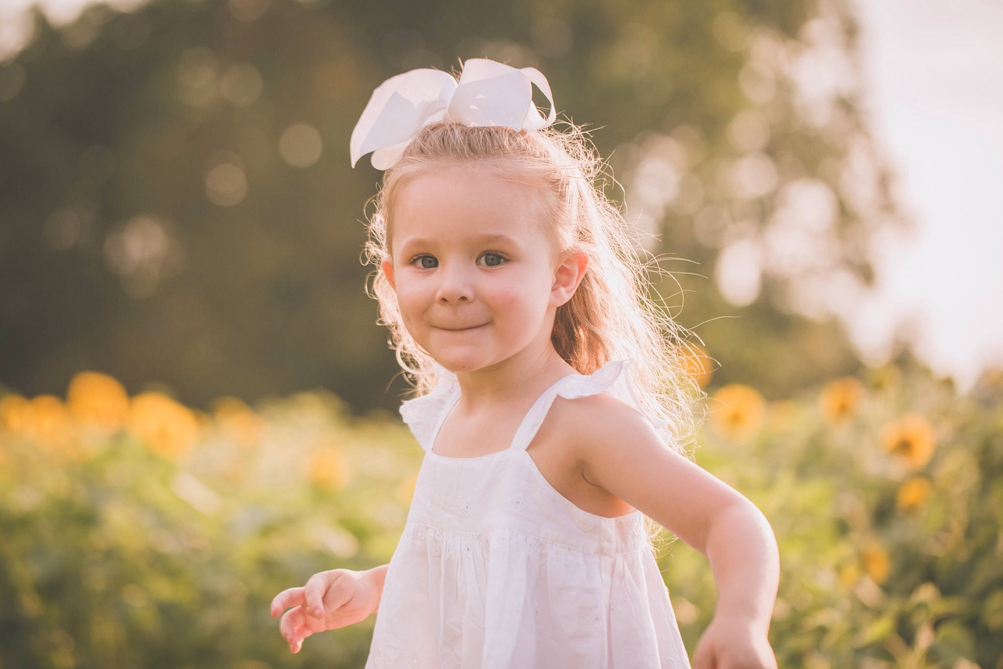 Harlowe is registered to the contest to win money with this photo: backlighting, beauty, blond, child, dress, grass, hair_accessory, head, headpiece, joy, light, people_in_nature, person, photograph, photography, portrait, skin, smile, summer, sunlight