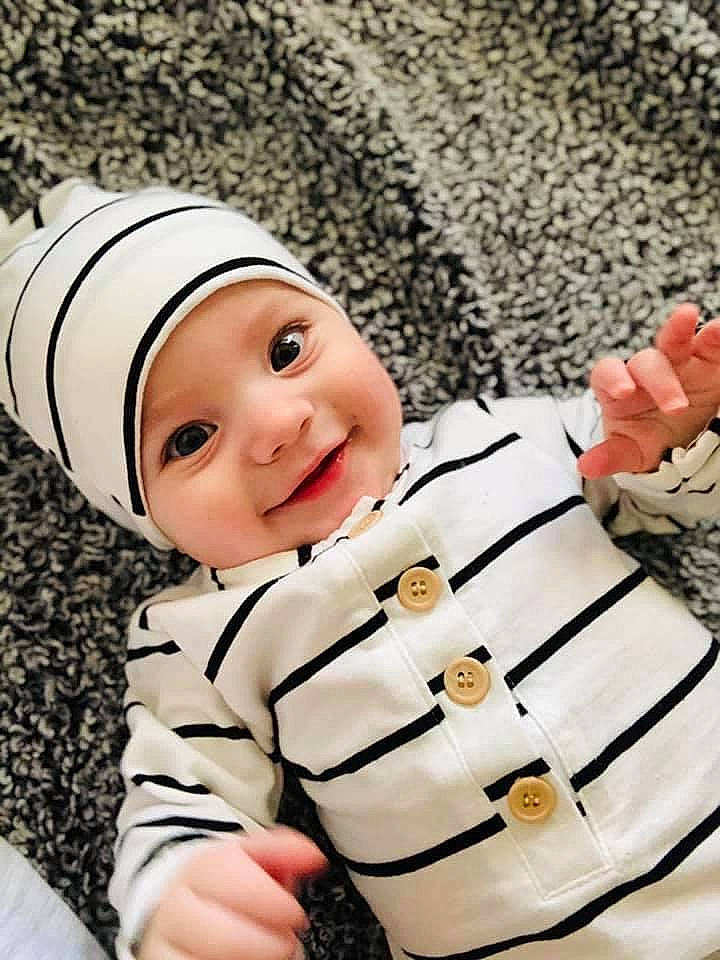 Zeplyn is registered to the contest to win money with this photo: baby, baby_toddler_clothing, cap, child, cool, face, fashion_accessory, font, fun, gesture, happy, headgear, headwear, joy, linens, pattern, person, sleeve, smile, textile