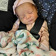 Jaliyah joined the competition — help win amazing prizes! baby, blanket, car_seat, child, closeup, cute, face, floral_pattern, headband, indoors, infant, newborn, peaceful, pink_clothing, portrait, resting, safety_harness, sleeping, soft_texture, toddler