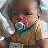 Jaliyah is registered to the contest to win money with this photo: baby, pacifier, blanket, mittens, sleepy, infant, cute, clothing, headwear, lying_down, soft_texture, newborn, resting, indoor, person, toddler, heart_pattern, closeup, comfort, adorable