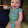 Calvin joined the competition — help win amazing prizes! baby, infant, smile, onesie, monkey_print, couch, furniture, happy, child, indoors, person, sitting, cute, face, head, hand, leg, carpet, clothing, young