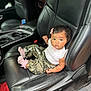 Elina joined the competition — help win amazing prizes! baby, child, car_interior, leather_seat, black_leather, pink_bow, curly_hair, camo_pants, pink_socks, white_top, infant, cute, portrait, sitting, seat, vehicle, interior, young_child, person, car