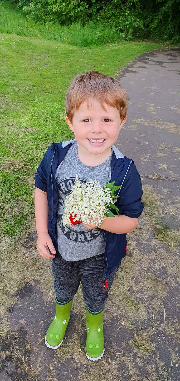 Logan James joined the competition — help win amazing prizes! child, flower, grass, joy, male, person, plant, smile, t_shirt, toddler, wildflower
