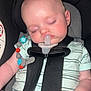 baby, car_seat, pacifier, sleeping, child, infant, safety_straps, clothing, hand, head, face, beads, toy, seat, closeup, cute, adorable, peaceful, indoor, rest