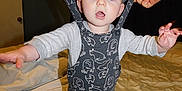 Bodie joined the competition — help win amazing prizes! baby, child, overalls, patterned_clothing, bed, blanket, hands, indoor, person, infant, standing, white_socks, blue_eyes, expression, cute, support, bedroom, door, curtains, sleepwear
