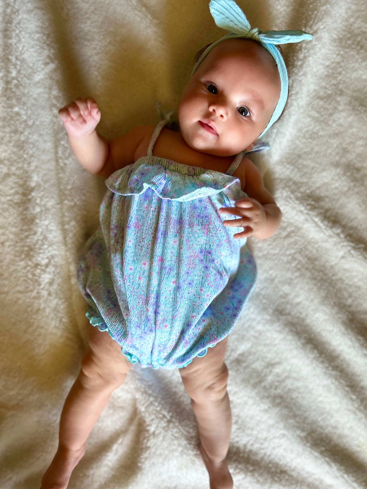 Maliah is registered to the contest to win money with this photo: arm, baby, baby_toddler_clothing, barefoot, day_dress, dress, eye, face, finger, gesture, happy, human_body, one_piece_garment, person, skin, sleeve, textile, thigh, toddler, trunk