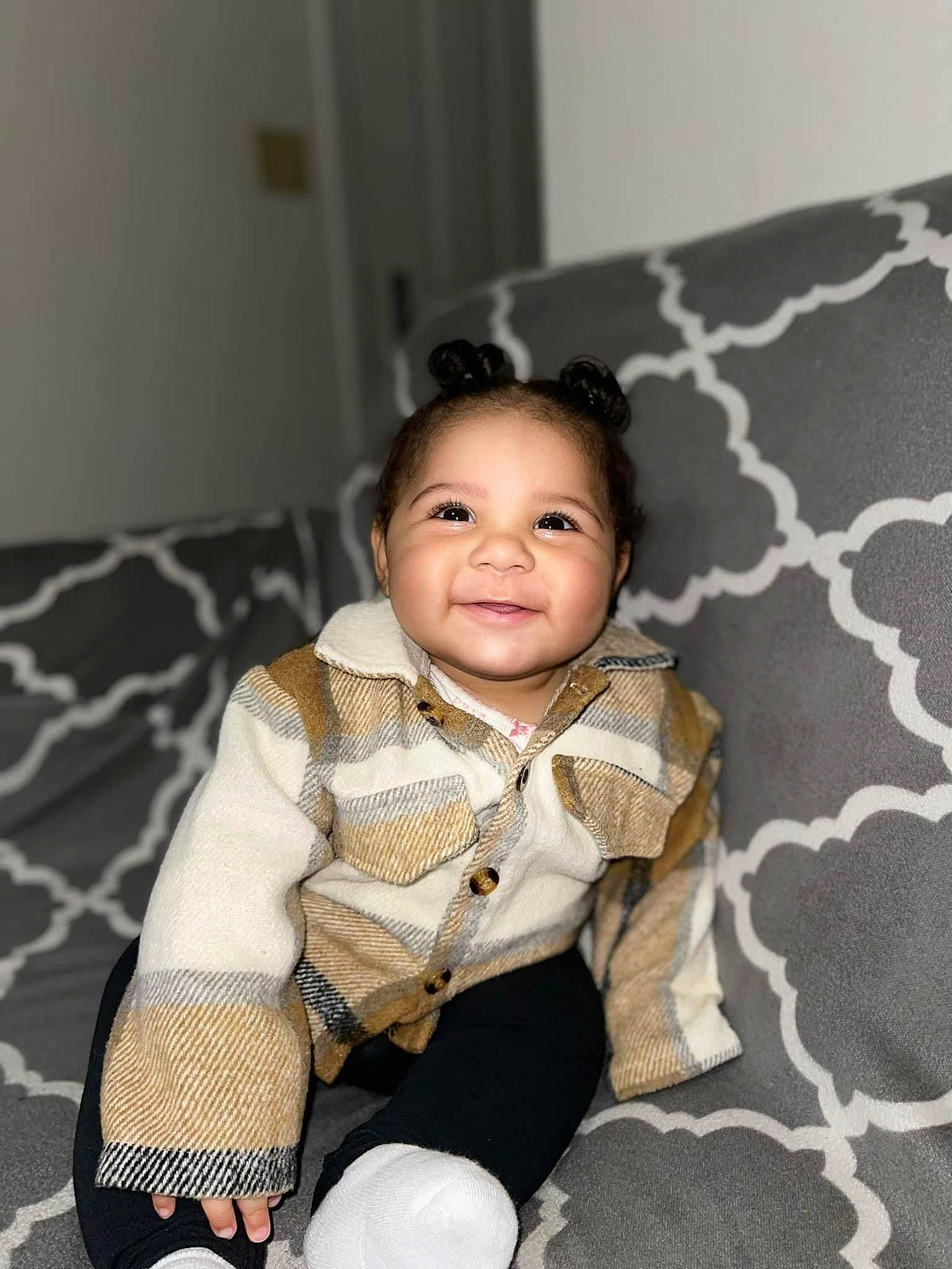 Khamari is registered to the contest to win money with this photo: baby, baby_toddler_clothing, cheek, child, collar, comfort, flash_photography, flooring, happy, linens, pattern, person, plaid, portrait_photography, room, sitting, sleeve, smile, textile, toddler