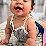 baby, child, tummy_time, smiling, striped_clothing, carpet, indoors, cheeks, hands, cute, infant, happy, person, portrait, crawling, short_sleeves, skin, hair, red_bow, floor