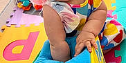 Amy joined the competition — help win amazing prizes! baby, child, colorful, colorful_clothing, curious, cute, exploring, face, foot, hands, headband, indoor, infant, patterned_clothing, play_mat, playtime, plush_toy, sitting, soft_toy, toy