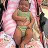 baby, baby_bump, child, cushion, cute, floral_pattern, foot, green_clothing, hand, happy, headband, infant, outdoor, person, pink_blanket, relaxed, skin, smiling, stroller, tongue_out
