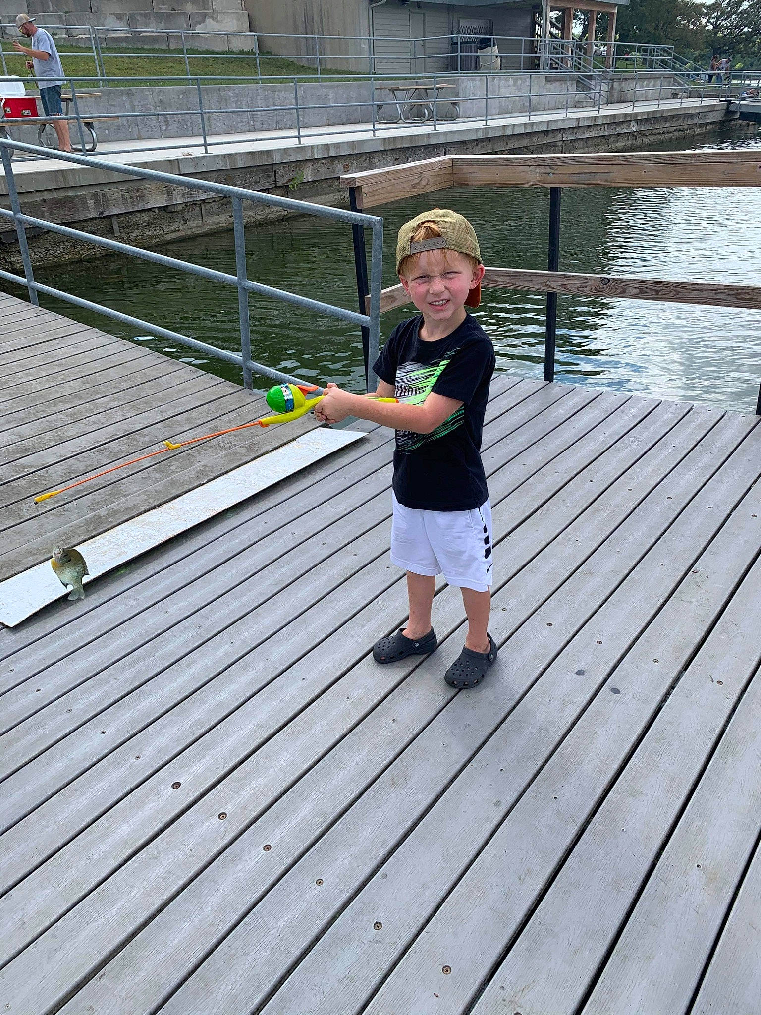 Johnathon joined the competition — help win amazing prizes! boardwalk, bridge, child, deck, dock, headwear, nonbuilding_structure, person, pier, vacation, walkway, water