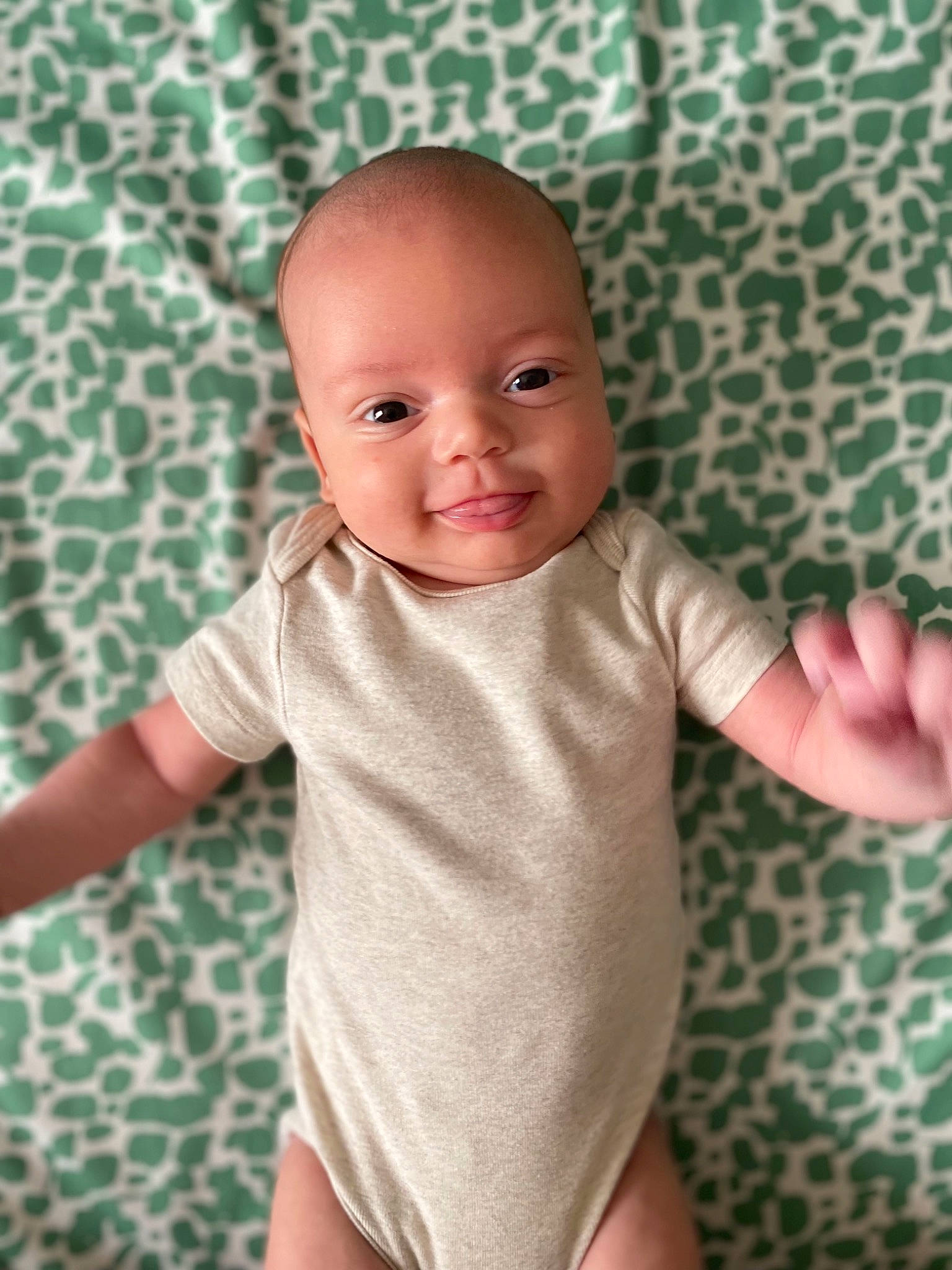 Fletcher is registered to the contest to win money with this photo: baby, baby_toddler_clothing, cheek, collar, comfort, finger, gesture, hand, human_body, infant_bodysuit, iris, joy, lip, mouth, person, pink, skin, sleeve, smile, stomach