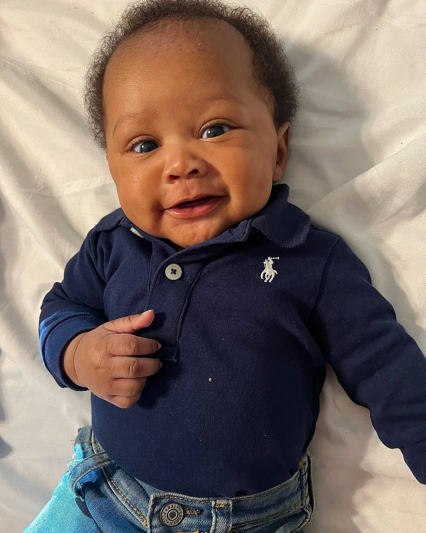 Alex is registered to the contest to win money with this photo: baby, baby_toddler_clothing, cheek, collar, denim, electric_blue, eye, face, gesture, happy, iris, jacket, nose, pattern, person, skin, sleeve, smile, t_shirt, thumb