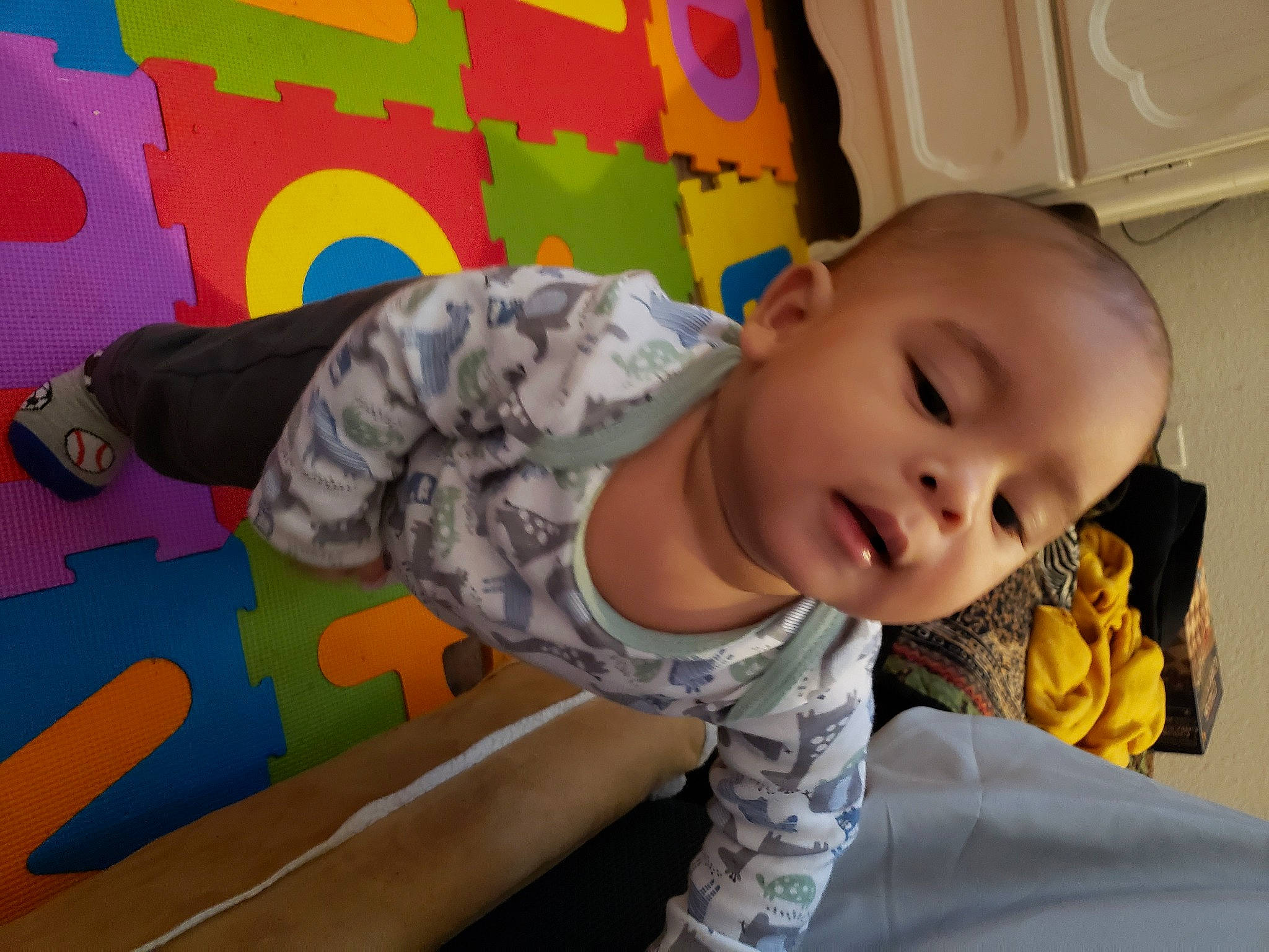 Jaz is registered to the contest to win money with this photo: baby, baby_products, baby_toddler_clothing, child, comfort, flooring, fun, happy, leisure, linens, pattern, person, play, room, sitting, sleeve, smile, t_shirt, textile, toddler