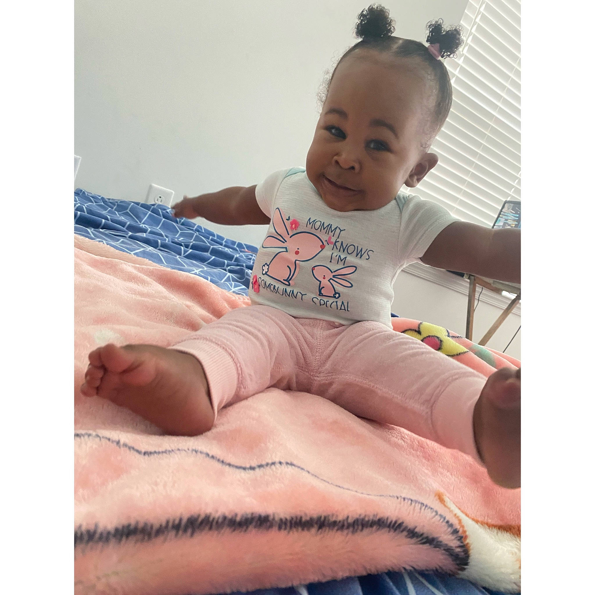 Asiyah joined the competition — help win amazing prizes! arm, baby, baby_toddler_clothing, bedding, child, comfort, fashion_accessory, happy, human_leg, knee, linens, neck, pattern, person, pink, sleeve, sportswear, t_shirt, thigh, throw_pillow