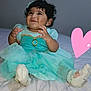 Merida is registered to the contest to win money with this photo: baby, child, dress, turquoise, sock, bed, smile, happy, cute, infant, portrait, clothing, hands, feet, indoors, person, tulle, fabric, cute_expression, heart_doodle