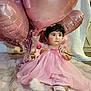 Merida is registered to the contest to win money with this photo: baby, pink_dress, balloons, heart_shaped, flower, curly_hair, blanket, indoor, cute, child, celebration, soft_texture, white_socks, festive, toddler, portrait, sitting, decorations, adorable, happy