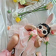 Merida is registered to the contest to win money with this photo: baby, pink_dress, bunny_ears, sunglasses, roses, sunflowers, blanket, flower, infant, cute, fluffy_slippers, tulle, lying_down, indoor, decorative_flowers, soft_texture, child, headwear, accessories, relaxing