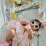 baby, pink_dress, bunny_ears, sunglasses, roses, sunflowers, blanket, flower, infant, cute, fluffy_slippers, tulle, lying_down, indoor, decorative_flowers, soft_texture, child, headwear, accessories, relaxing