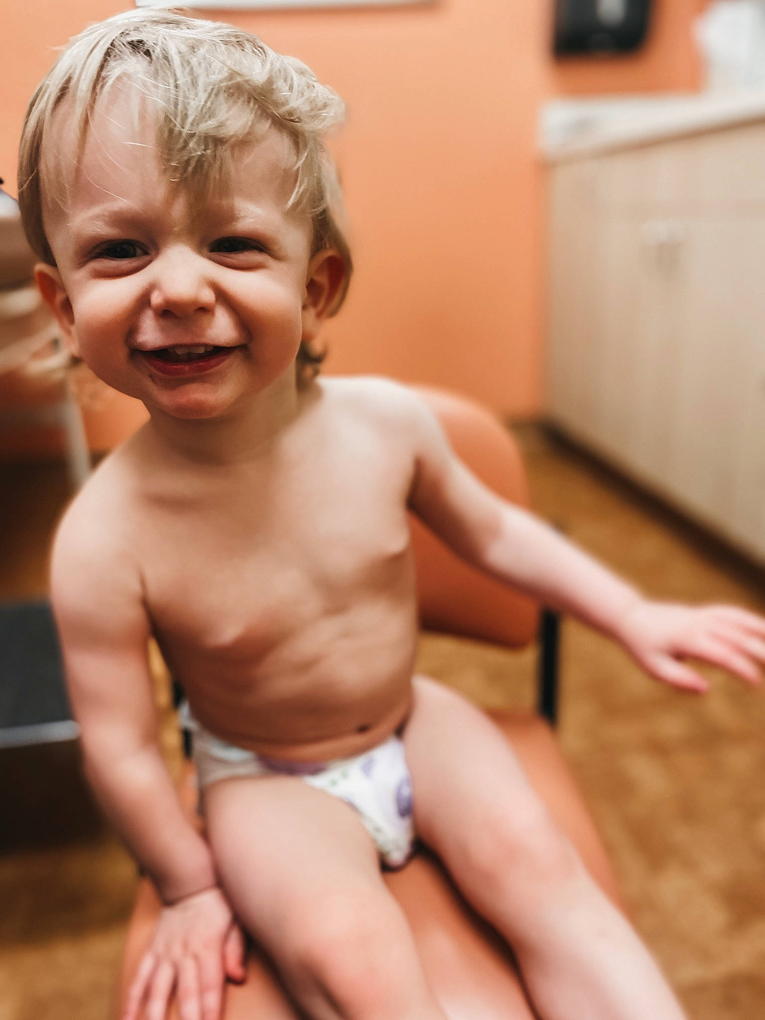 Jakson is registered to the contest to win money with this photo: baby, barechested, blond, cheek, chest, child, face, facial_expression, finger, fun, hand, happy, joy, laugh, muscle, person, sitting, skin, smile, thumb