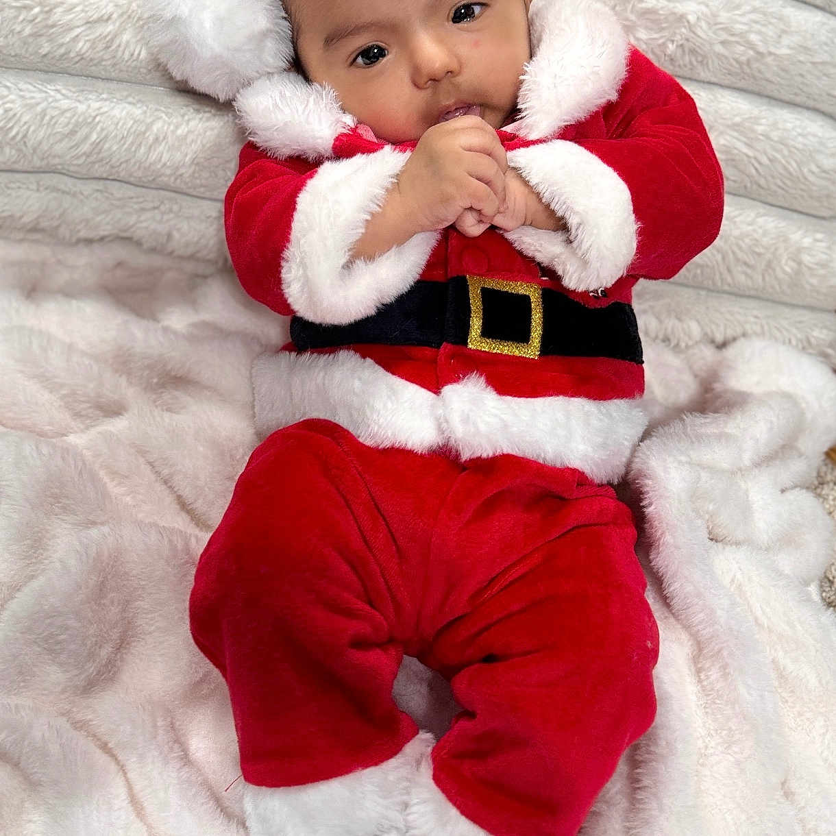 Avyansh is registered to the contest to win money with this photo: baby, blanket, child, christmas, cozy, cute, festive, hat, holiday, indoors, infant, lying_down, person, portrait, red_clothing, santa_claus_costume, smiling, soft_texture, warm, white_fur