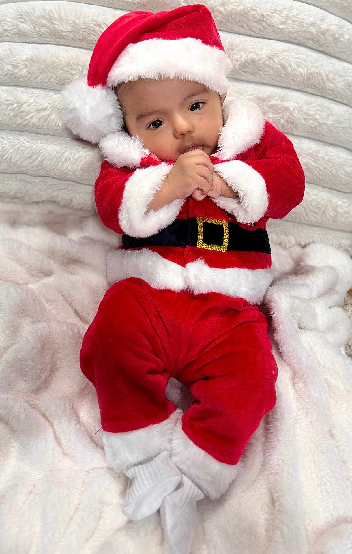 Avyansh is registered to the contest to win money with this photo: baby, blanket, child, christmas, cozy, cute, festive, hat, holiday, indoors, infant, lying_down, person, portrait, red_clothing, santa_claus_costume, smiling, soft_texture, warm, white_fur