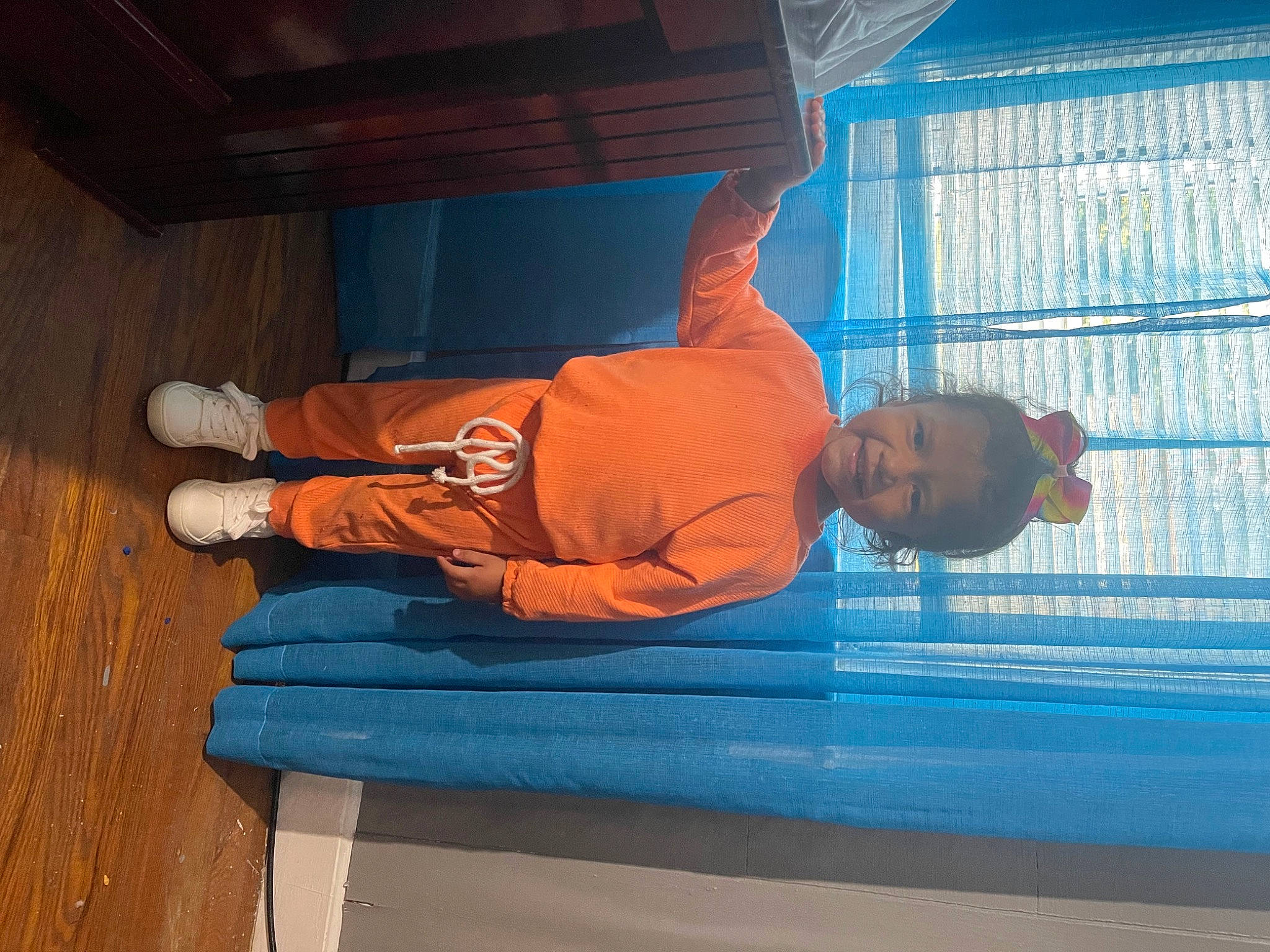 Geraldine joined the competition — help win amazing prizes! comfort, denim, elbow, electric_blue, flooring, fun, hardwood, hat, knee, leisure, person, room, sitting, sky, varnish, water, wood